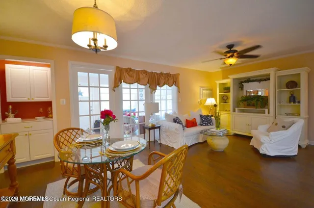 a view of a dining room with furniture and chandelier