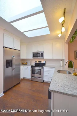 a kitchen with a refrigerator sink and stove