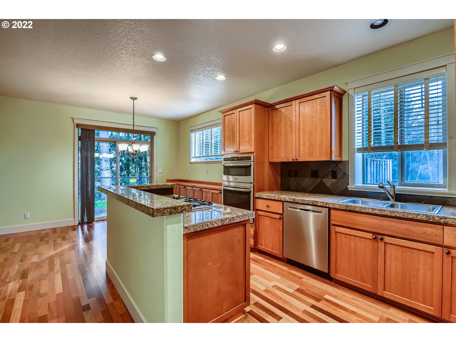 14656 Southwest 164th Avenue Tigard, OR 97224 - Photo 12 of 31 a kitchen with kitchen island granite countertop a sink window and cabinets