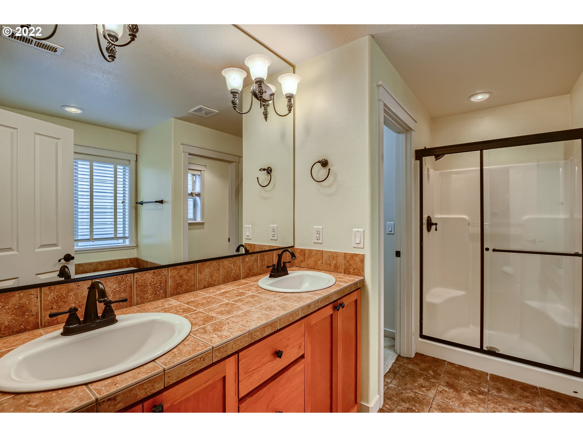 14656 Southwest 164th Avenue Tigard, OR 97224 - Photo 19 of 31 a bathroom with a granite countertop sink a mirror and a shower