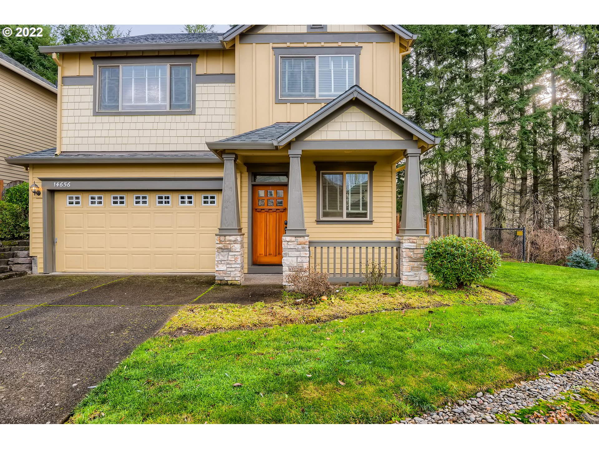 14656 Southwest 164th Avenue Tigard, OR 97224 - Photo 2 of 31 a front view of a house with a yard and garage