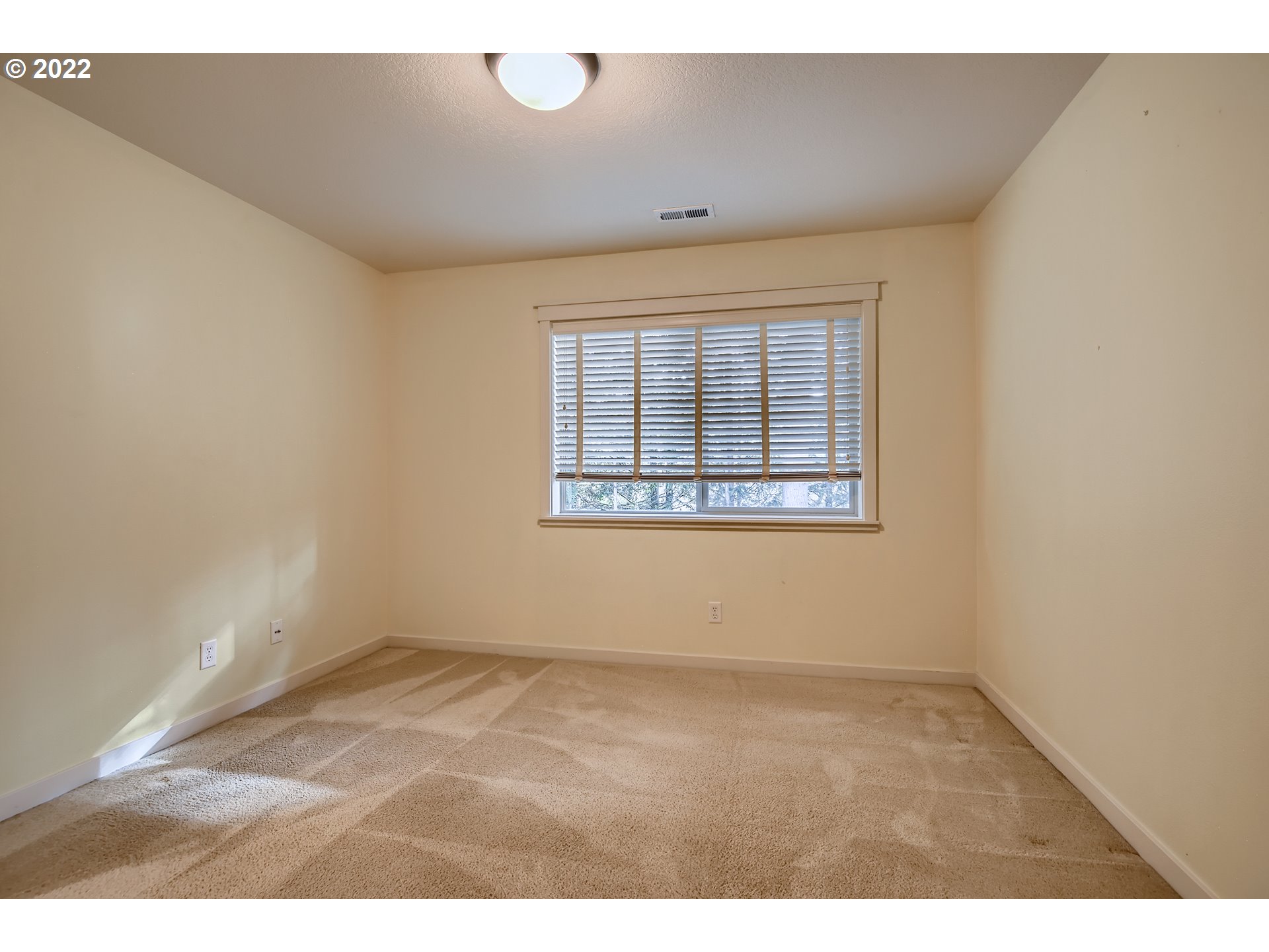 14656 Southwest 164th Avenue Tigard, OR 97224 - Photo 27 of 31 an empty room with wooden floor and windows