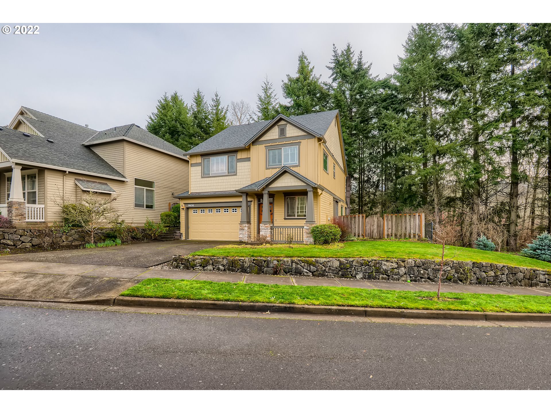 14656 Southwest 164th Avenue Tigard, OR 97224 - Photo 3 of 31 a front view of a house with a garden