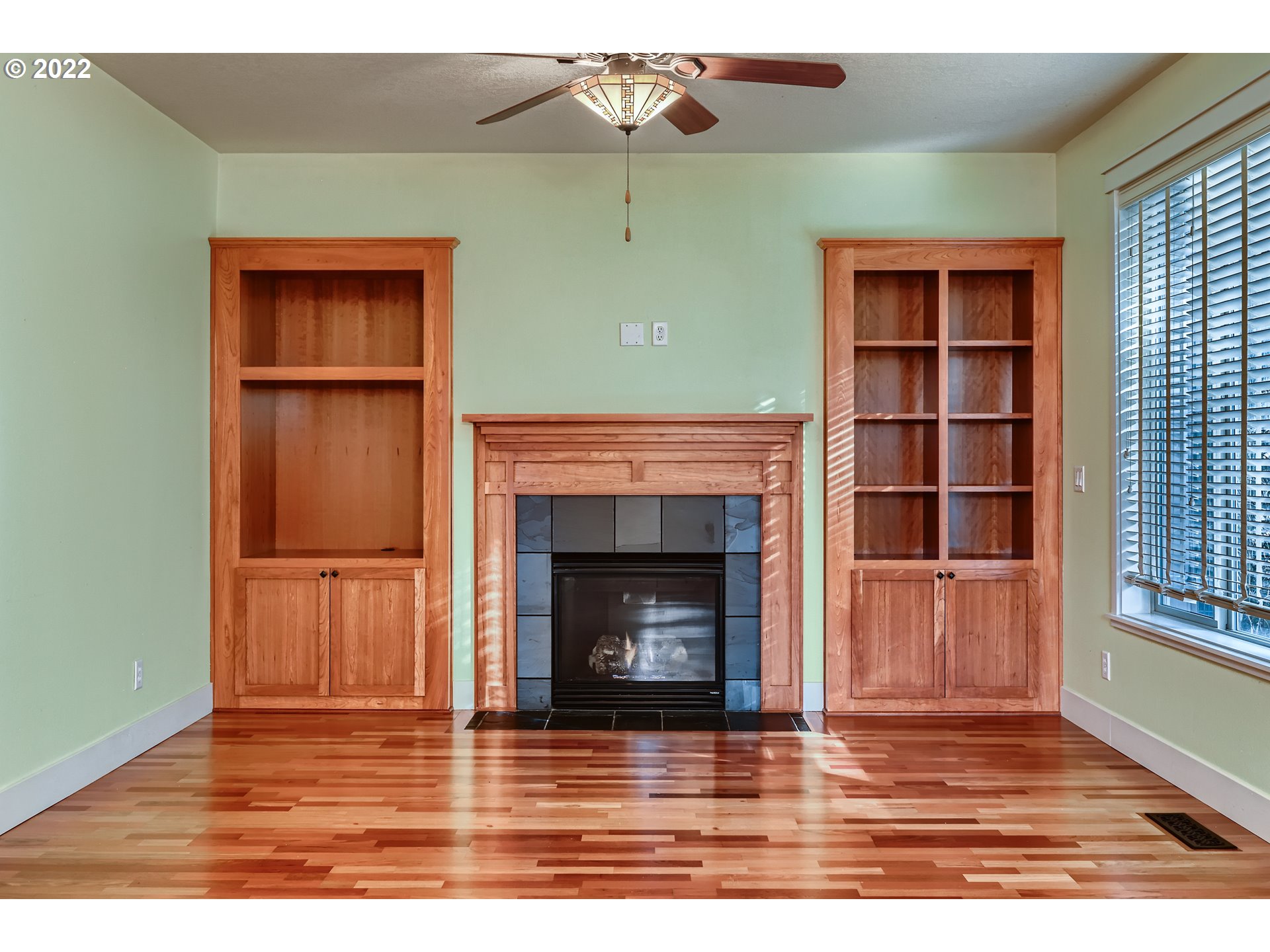 14656 Southwest 164th Avenue Tigard, OR 97224 - Photo 6 of 31 a view of an empty room with wooden floor fireplace and a window