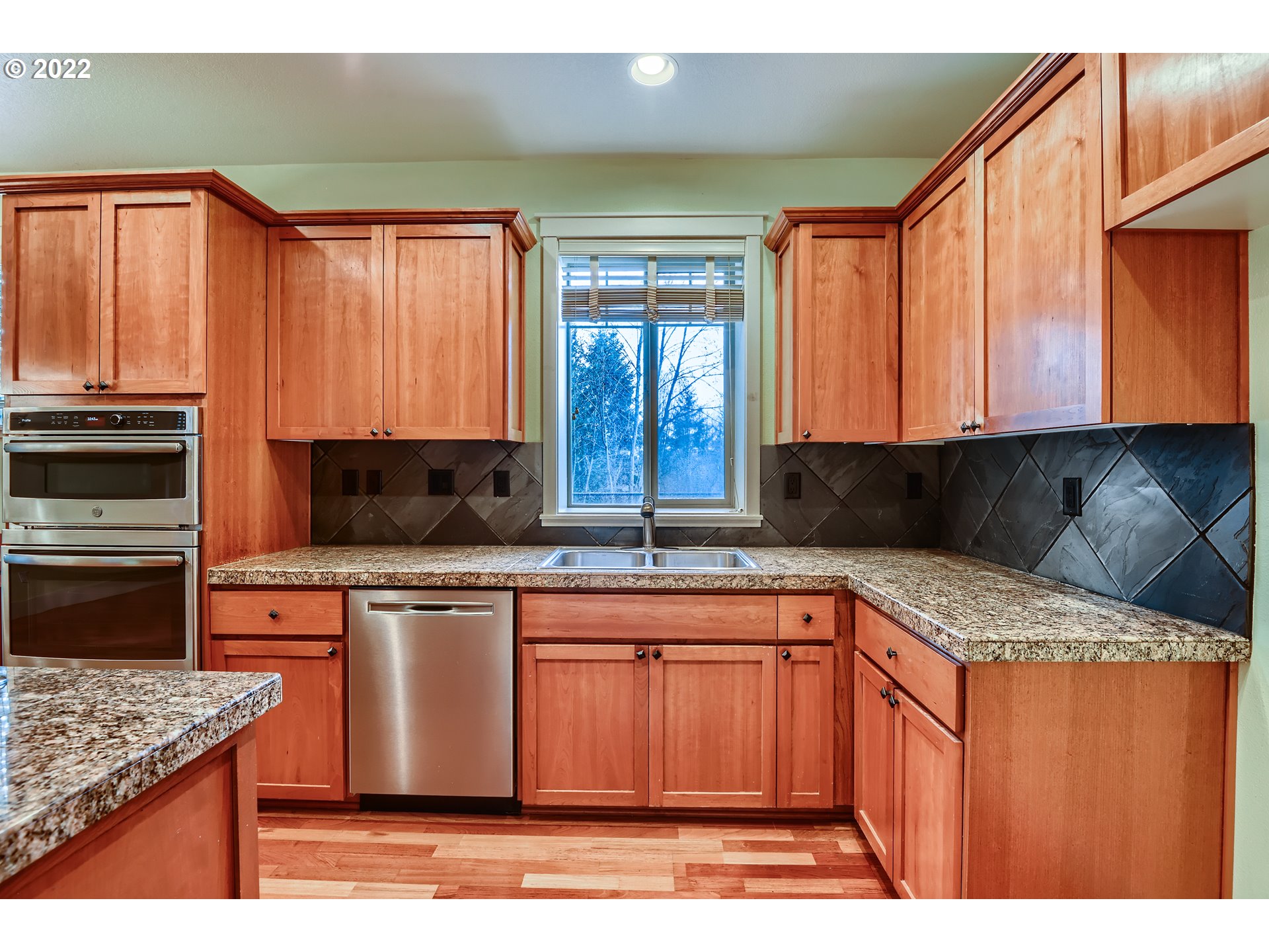 14656 Southwest 164th Avenue Tigard, OR 97224 - Photo 8 of 31 a kitchen with stainless steel appliances granite countertop a sink stove and refrigerator
