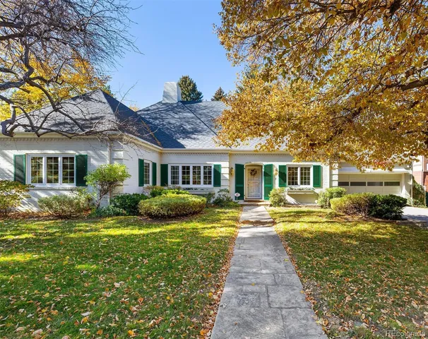 a front view of a house with swimming pool and porch