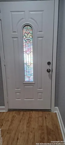 a view of front door with wooden door