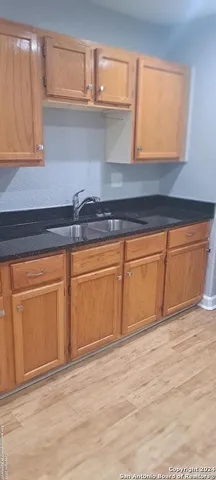 a view of a kitchen with wooden floor