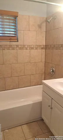 a bathroom with a bathtub and shower