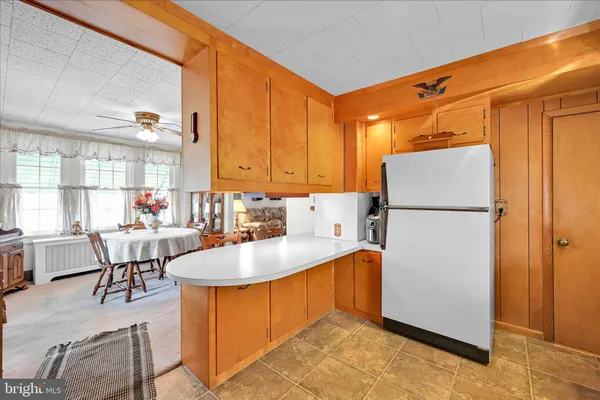 a kitchen with refrigerator and cabinets
