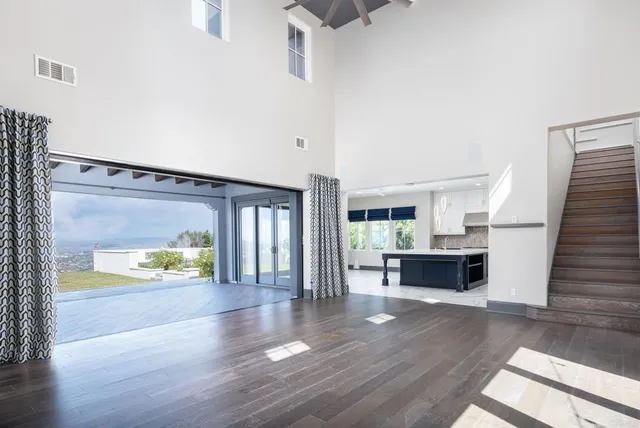 a large white kitchen with a large counter top appliances and cabinets
