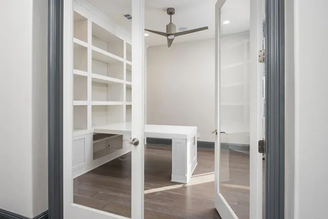 wooden floor in an empty room with a window