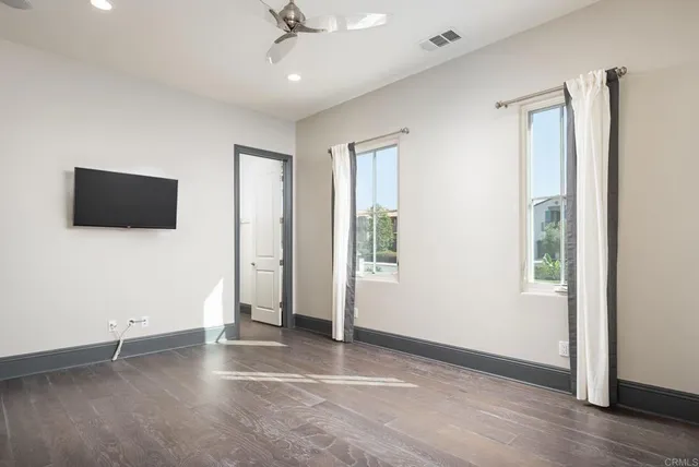 an aerial view of residential houses with outdoor space and trees