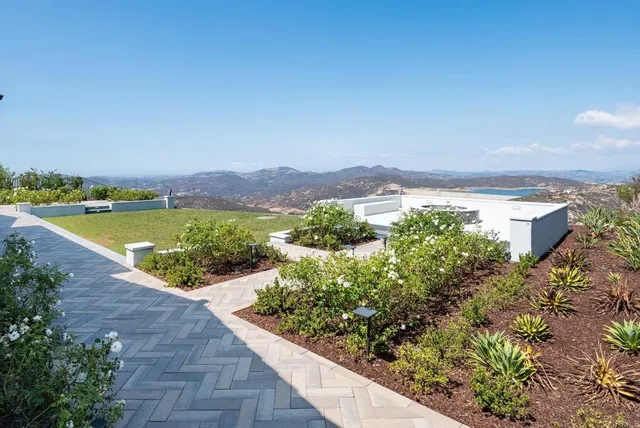 a view of a house with a yard and plants