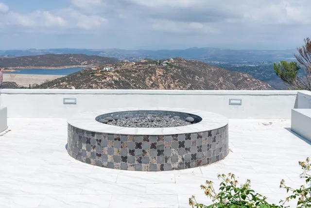 an aerial view of residential houses with outdoor space and trees