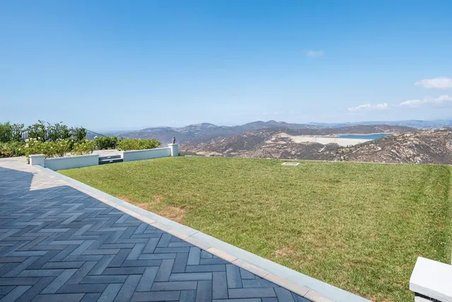 a view of a backyard with large trees