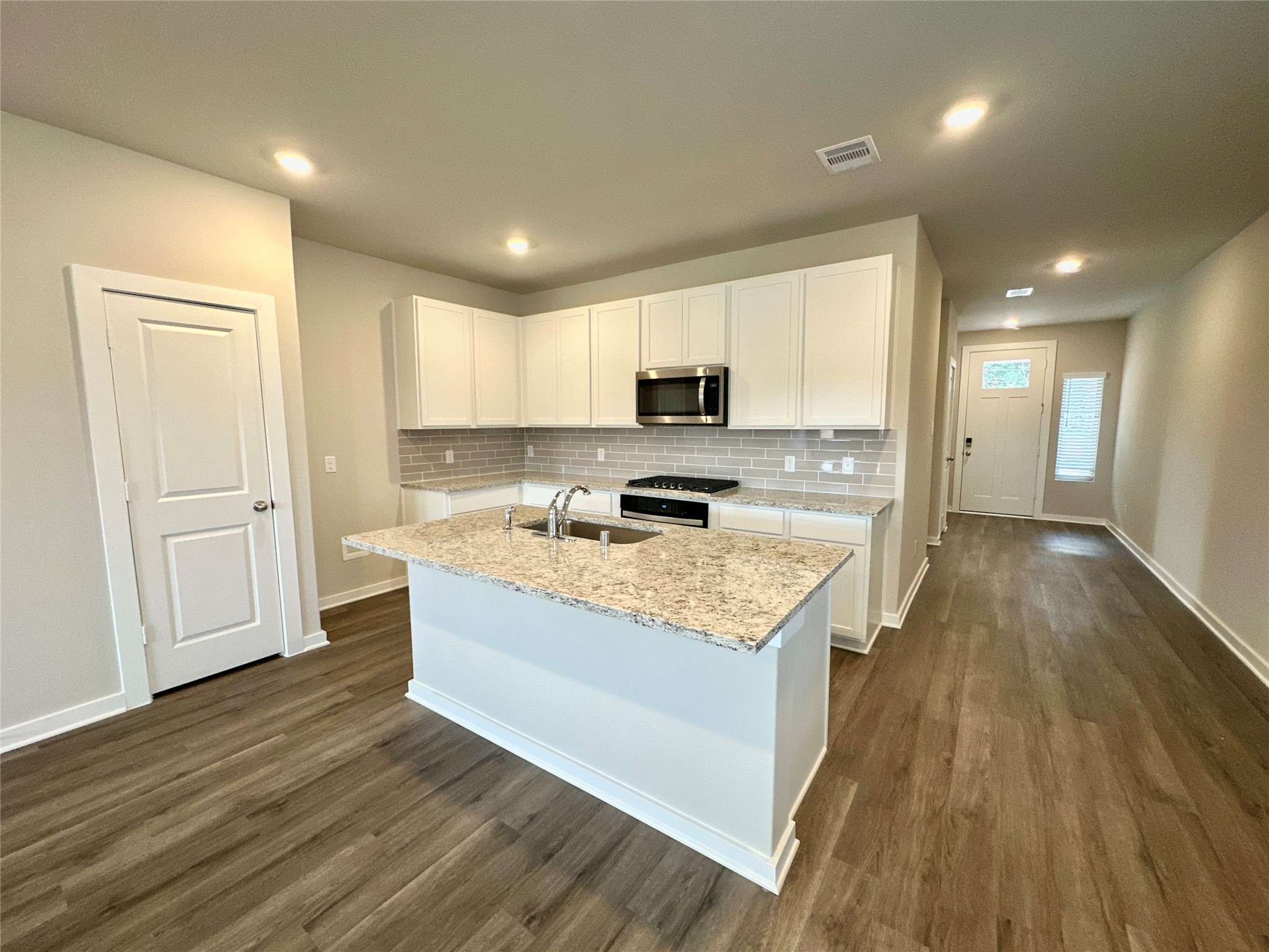12164 Ridge Top Drive Conroe, TX 77304 - Photo 5 of 23 a large kitchen with stainless steel appliances granite countertop a stove a sink and a refrigerator