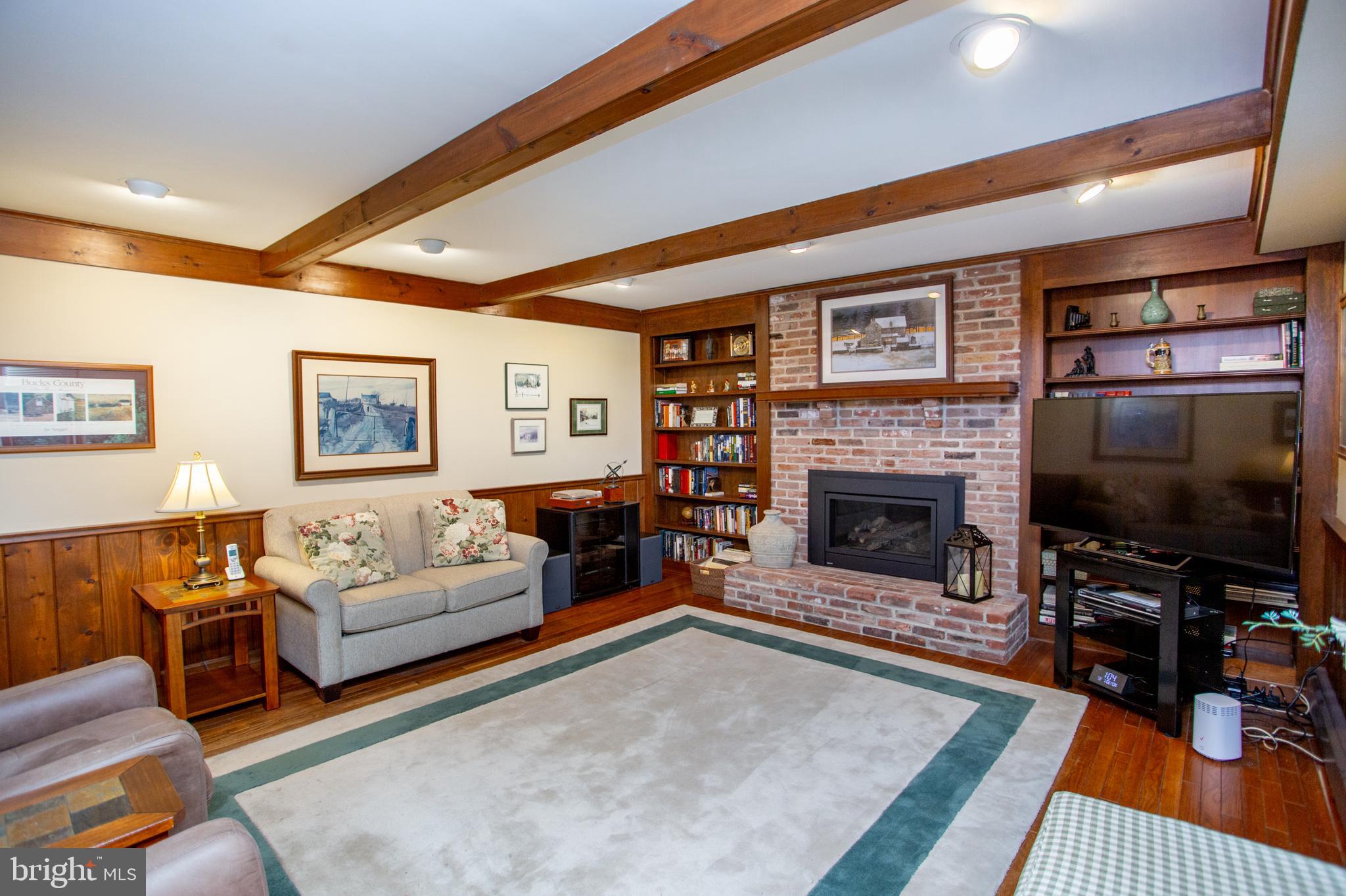 950 Camelot Road Furlong, PA 18925 - Photo 26 of 106 a living room with furniture a flat screen tv and a fireplace