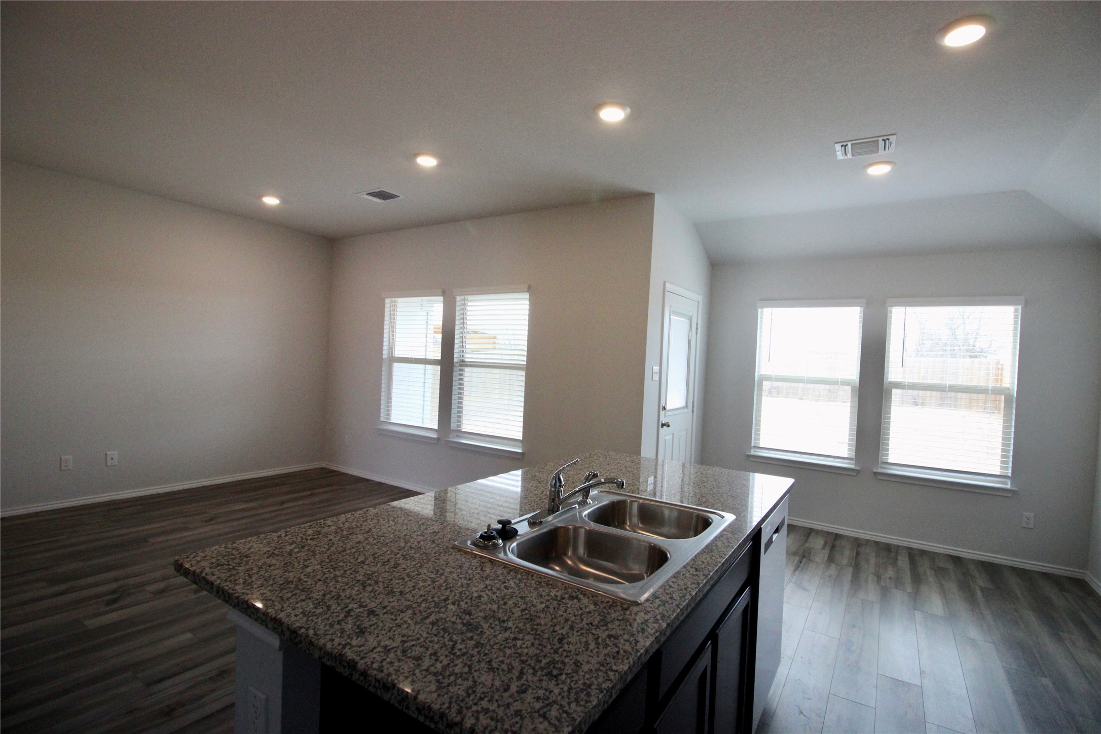 602 Wyatt Way Jarrell, TX 76537 - Photo 8 of 8 Kitchen with dark wood finished floors, open floor plan, a center island with sink, recessed lighting, and dishwasher
