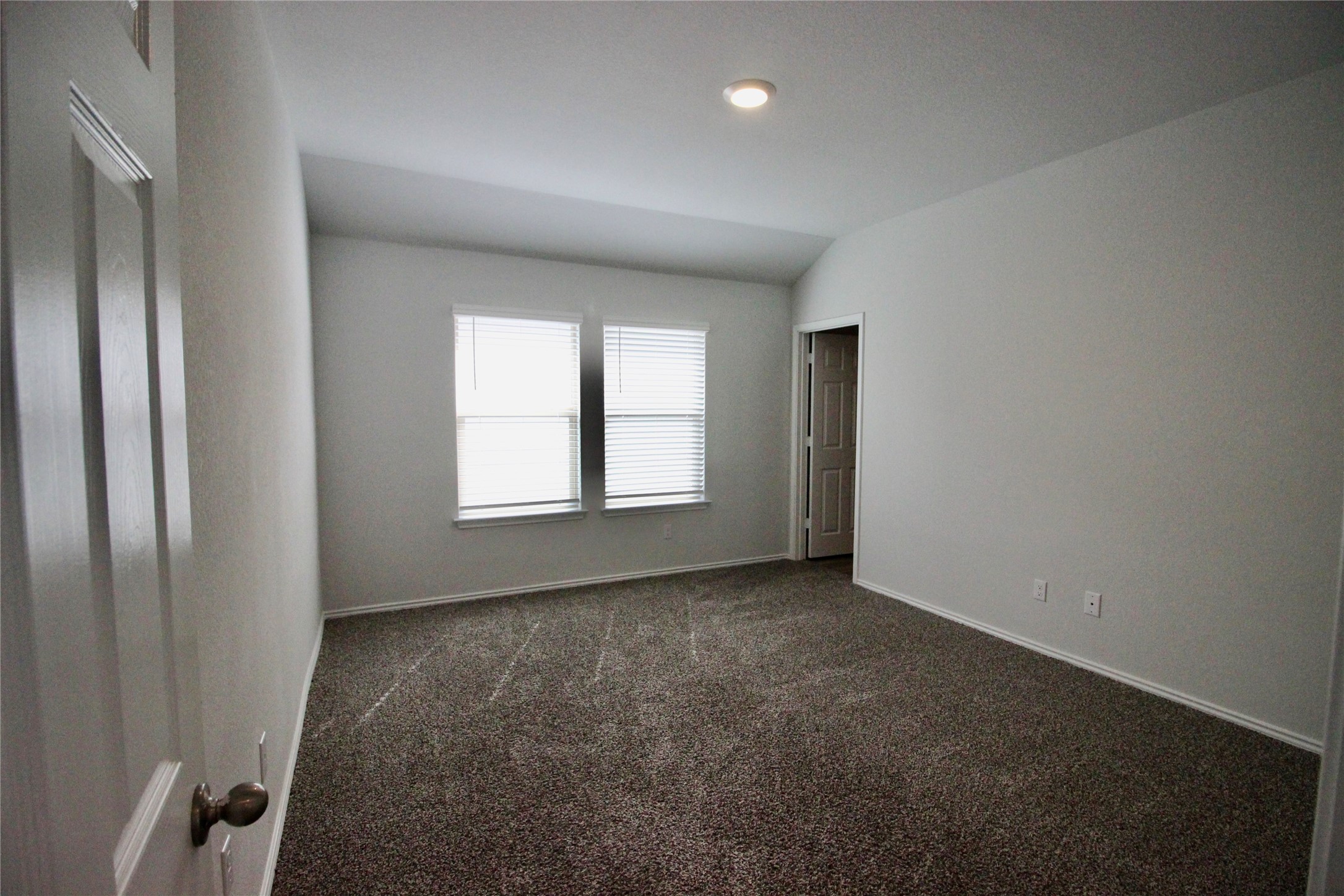 602 Wyatt Way Jarrell, TX 76537 - Photo 4 of 8 Empty room featuring dark carpet and lofted ceiling