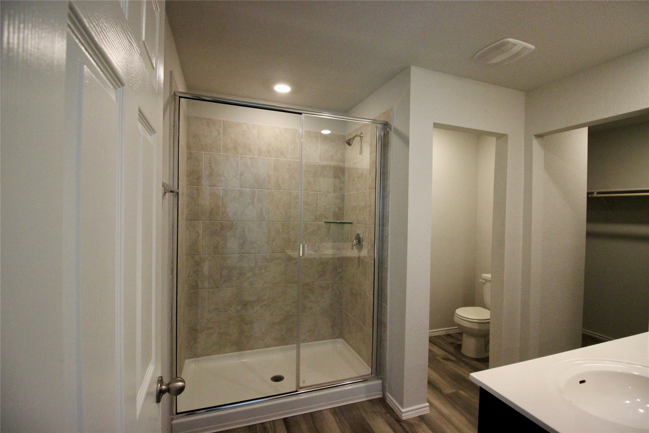 602 Wyatt Way Jarrell, TX 76537 - Photo 5 of 8 Full bath featuring a stall shower, vanity, dark wood finished floors, a walk in closet, and recessed lighting