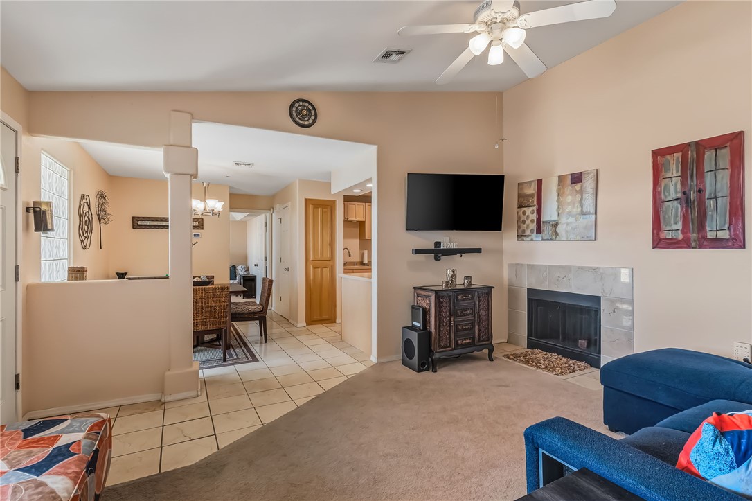 3408 Sunriver Road, Unit 208 Bullhead City, AZ 86429 - Photo 11 of 47 a living room with furniture a flat screen tv and a fireplace