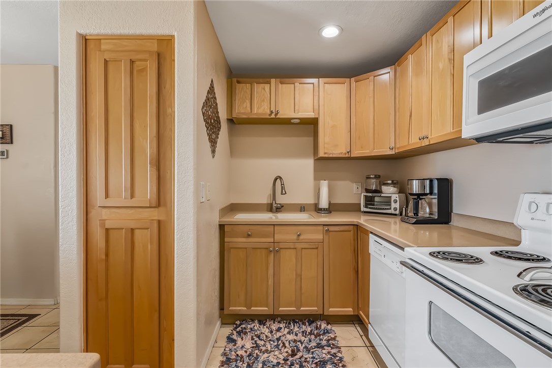 3408 Sunriver Road, Unit 208 Bullhead City, AZ 86429 - Photo 16 of 47 a kitchen with stainless steel appliances granite countertop a stove sink and cabinets