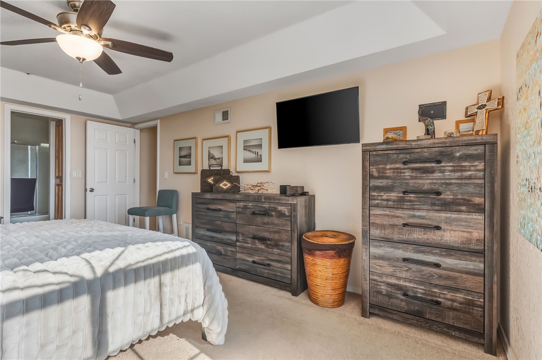 3408 Sunriver Road, Unit 208 Bullhead City, AZ 86429 - Photo 19 of 47 a bedroom with a bed and a flat screen tv