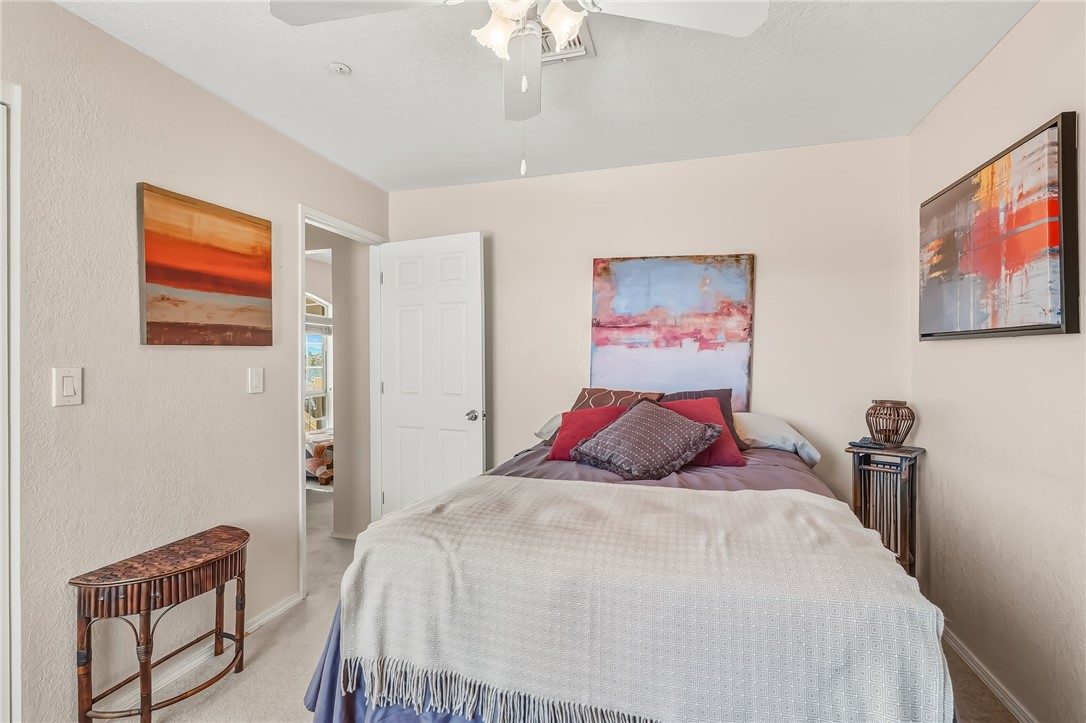 3408 Sunriver Road, Unit 208 Bullhead City, AZ 86429 - Photo 26 of 47 a bedroom with a bed and a chandelier