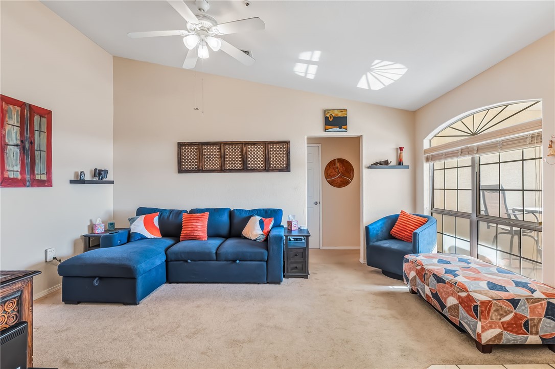 3408 Sunriver Road, Unit 208 Bullhead City, AZ 86429 - Photo 9 of 47 a living room with furniture and a chandelier