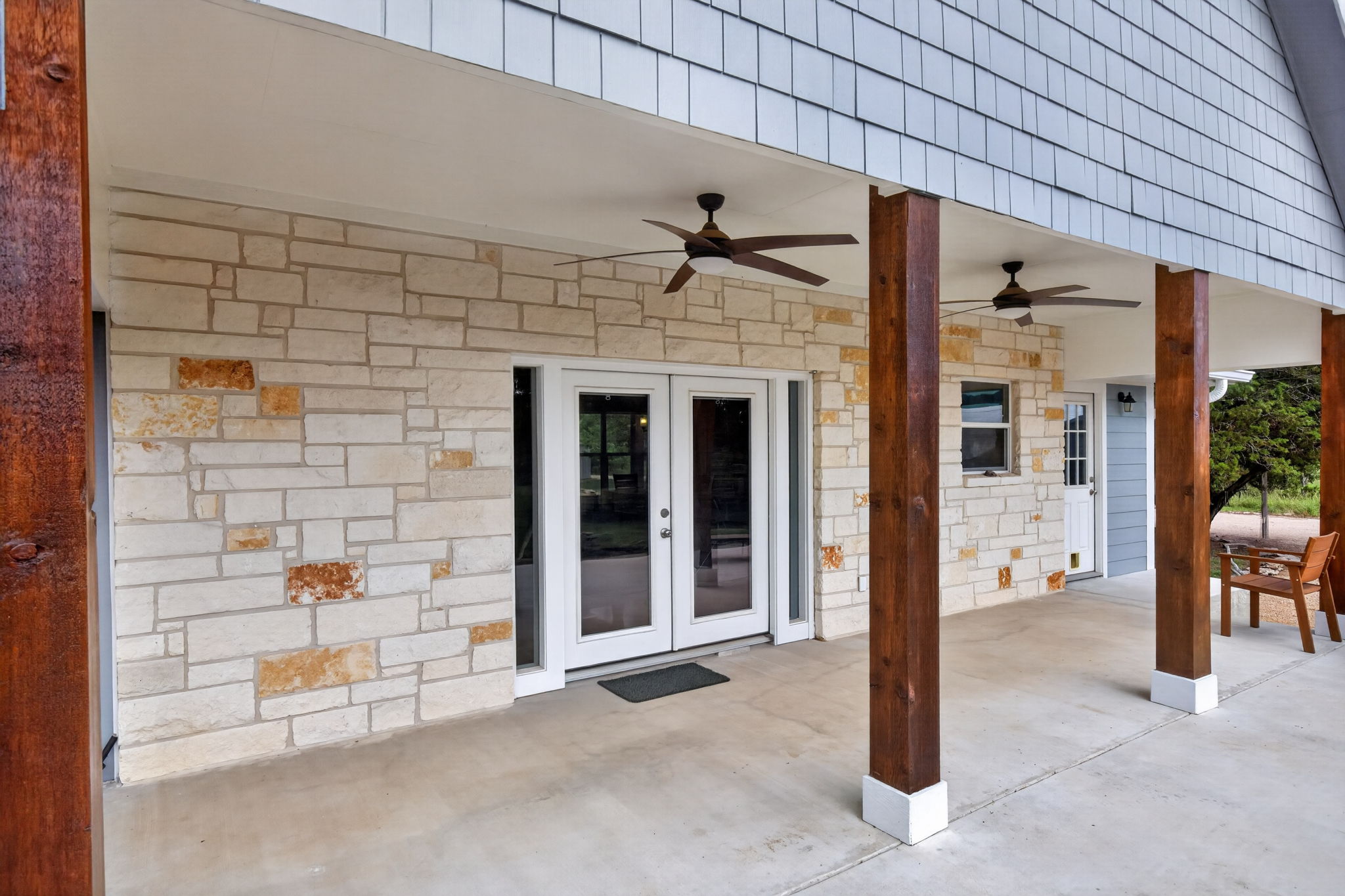 207 Deer Ridge Drive Burnet, TX 78611 - Photo 9 of 36 A spacious covered patio with wooden pillars offers a relaxing outdoor retreat.
