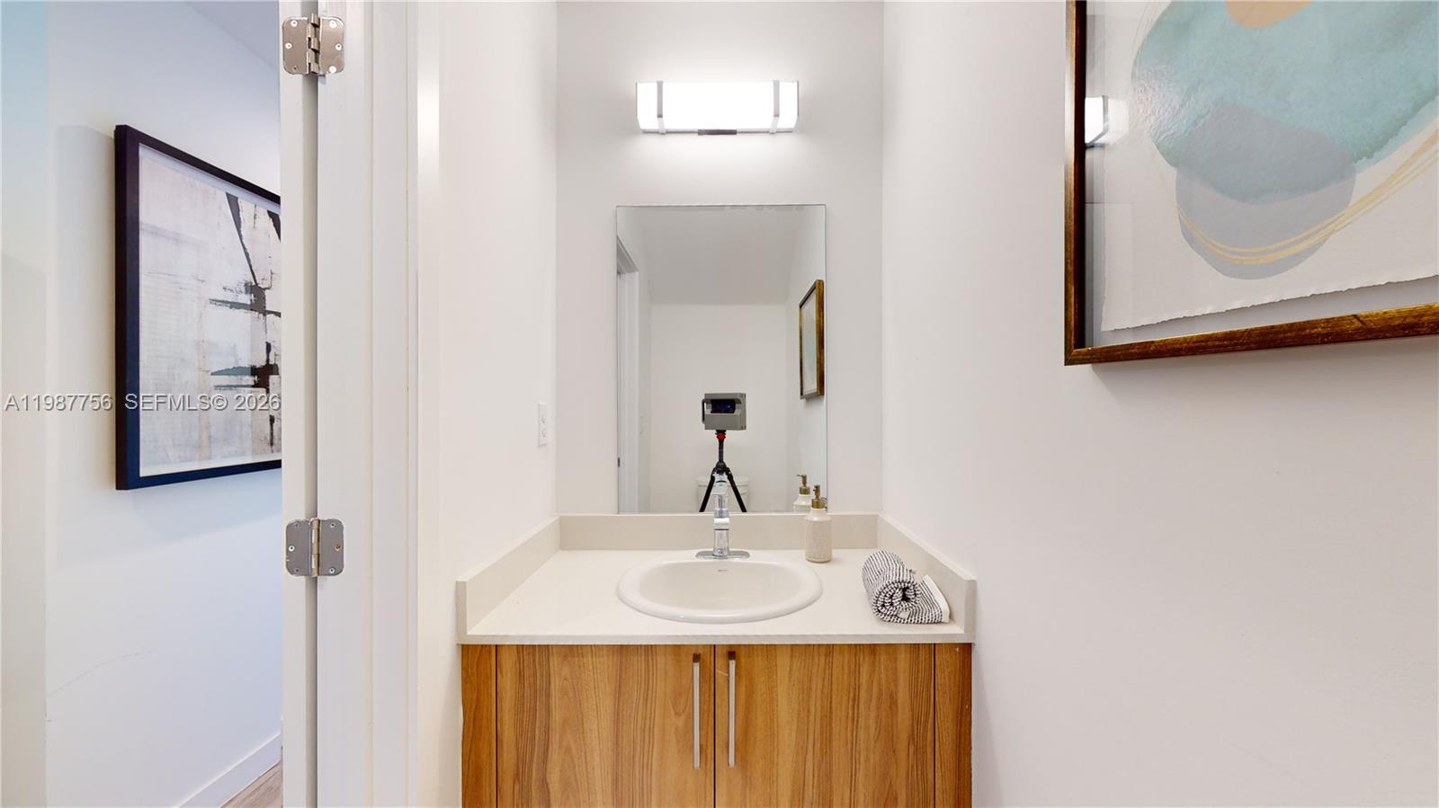 24705 Southwest 129th Avenue, Unit 110 Homestead, FL 33032 - Photo 12 of 33 a bathroom with a sink vanity and a mirror
