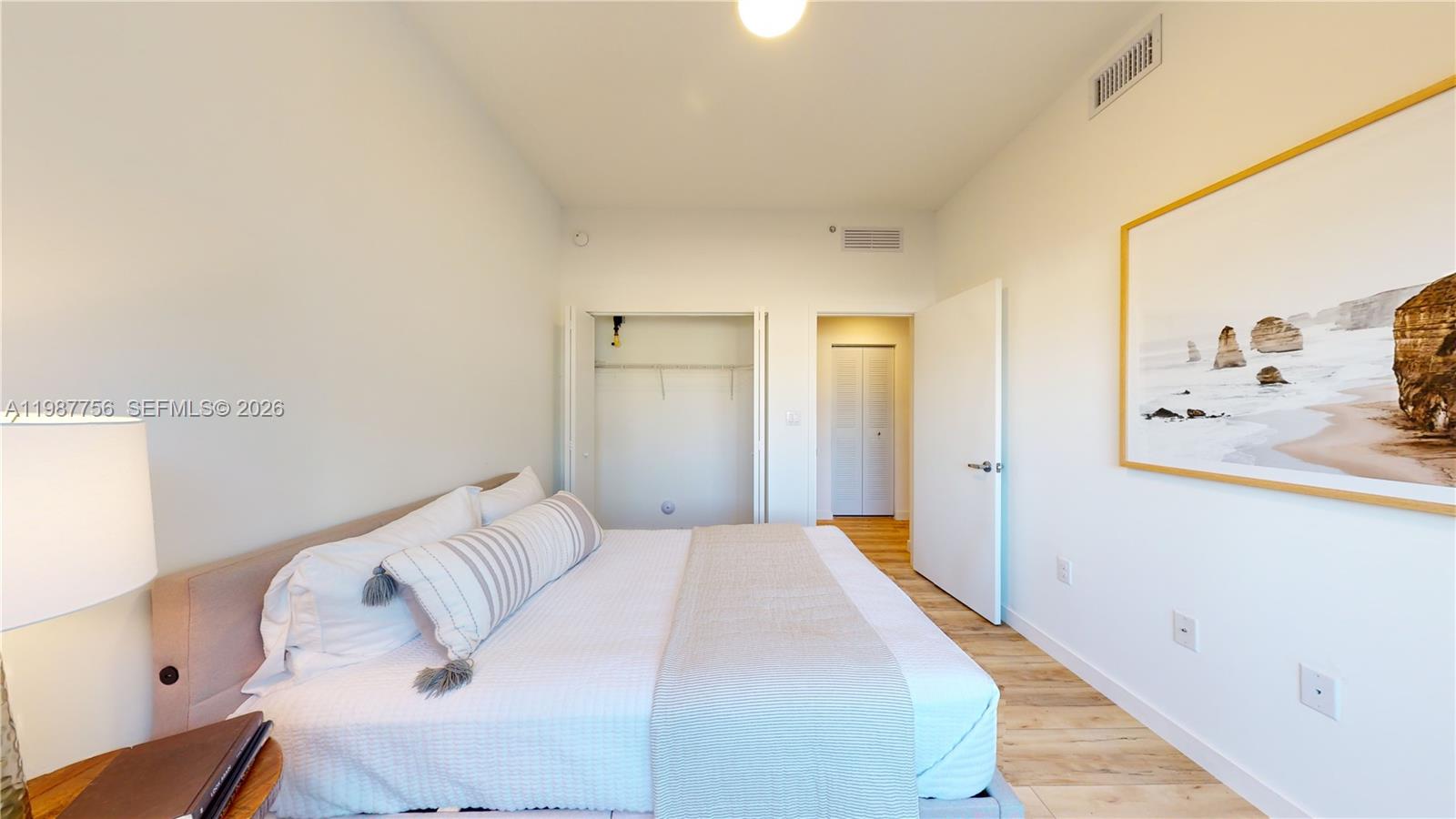 24705 Southwest 129th Avenue, Unit 110 Homestead, FL 33032 - Photo 22 of 33 a bedroom with a bed and a mirror