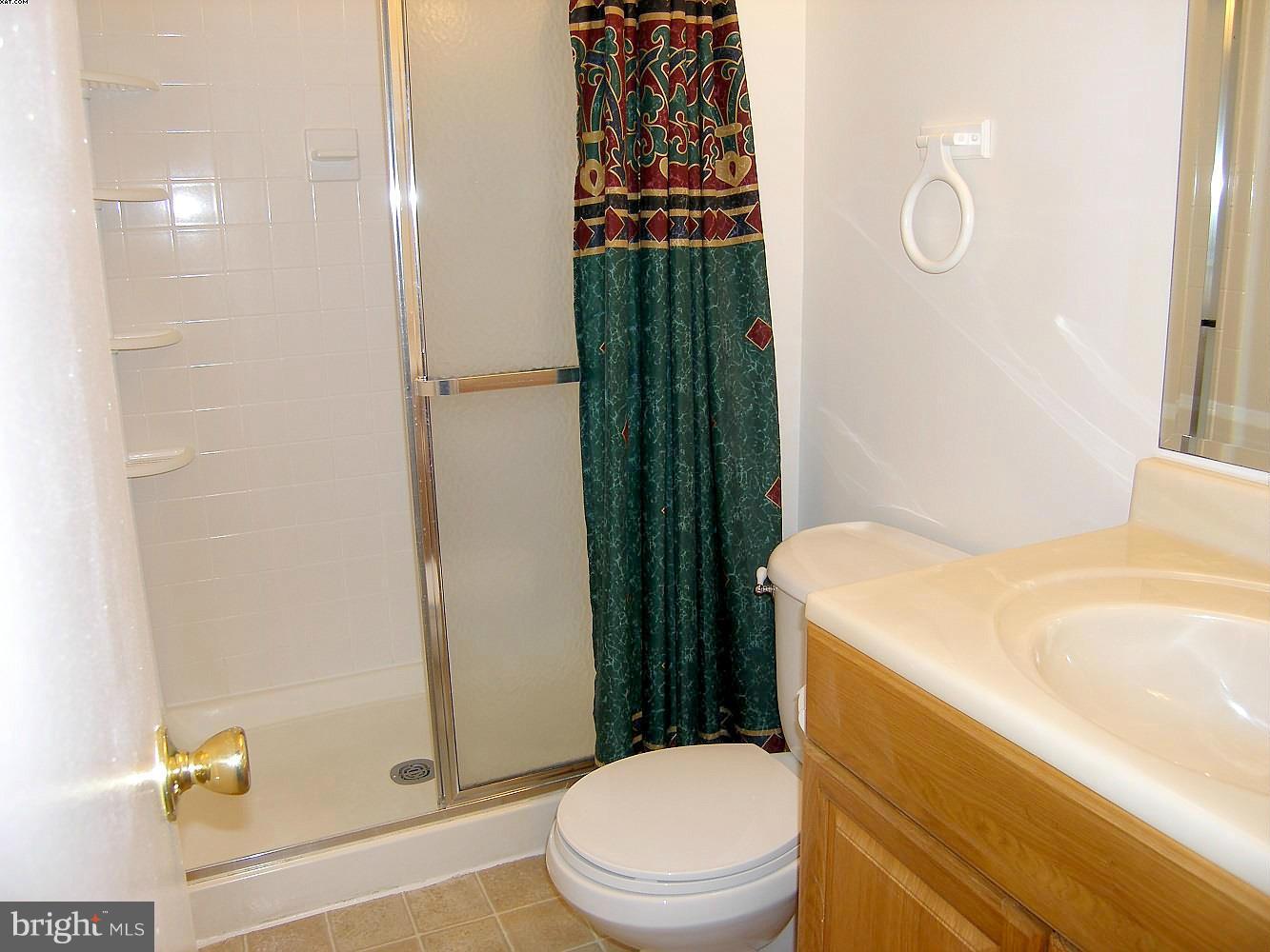 14906 McKisson Court, Unit B Silver Spring, MD 20906 - Photo 14 of 27 a bathroom with a sink a toilet and shower