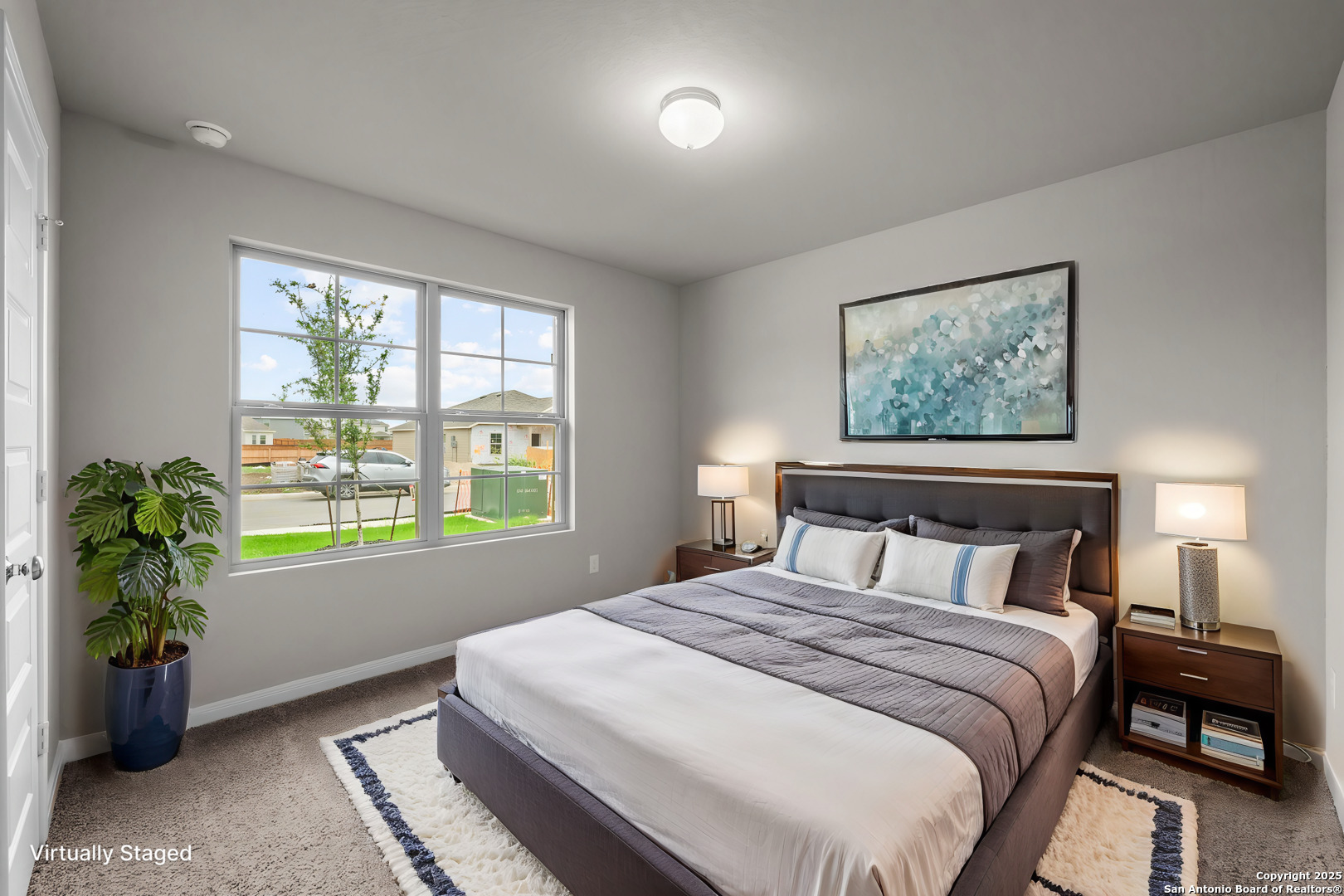 3019 Wembley Way Converse, TX 78109 - Photo 9 of 27 a bedroom with a large bed and a potted plant