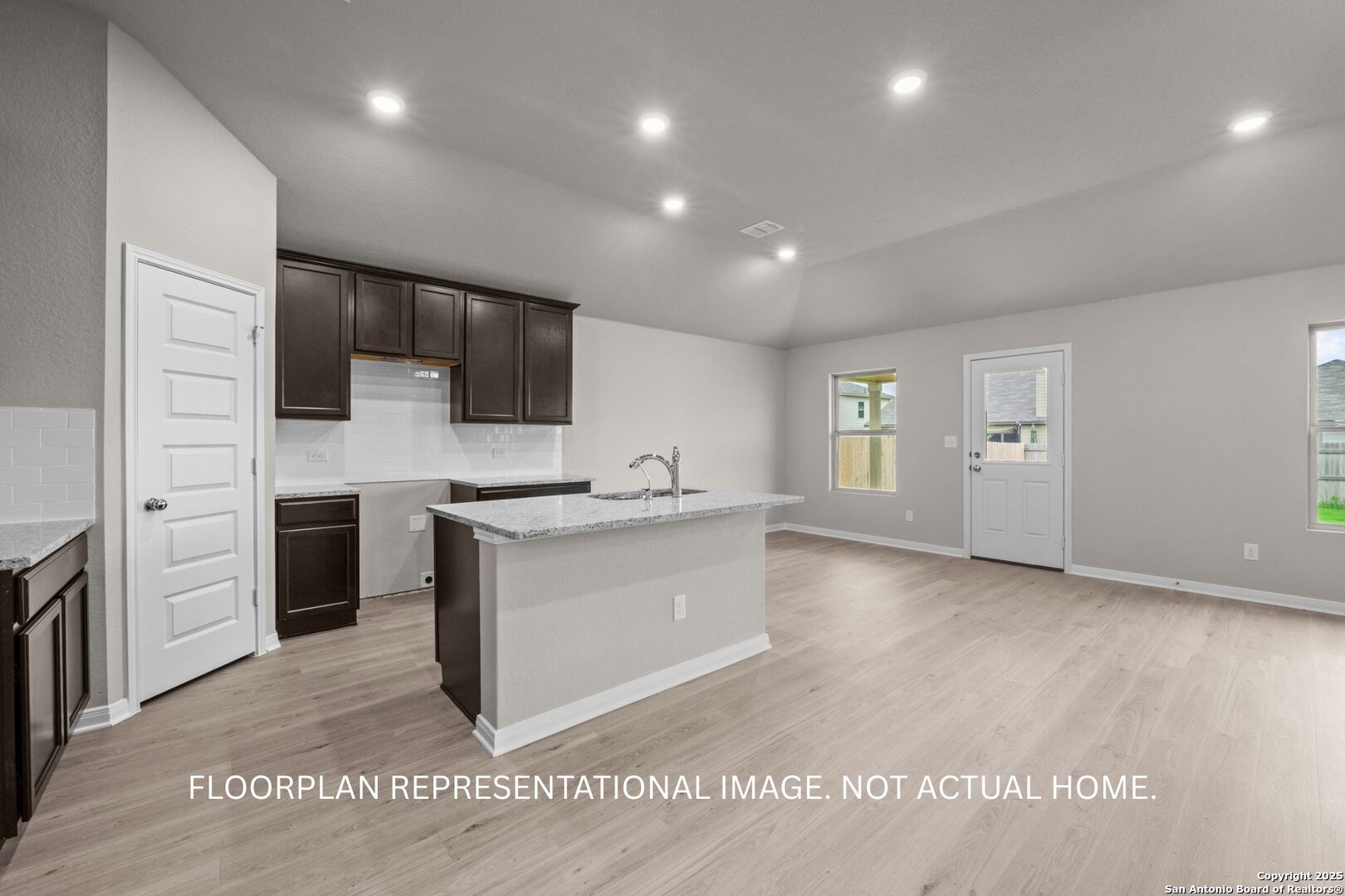 3019 Wembley Way Converse, TX 78109 - Photo 10 of 27 a large white kitchen with kitchen island a sink stainless steel appliances and cabinets