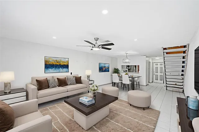 a living room with furniture and a ceiling fan