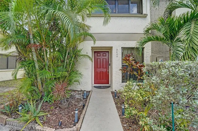 a couple of flower plants in front of house