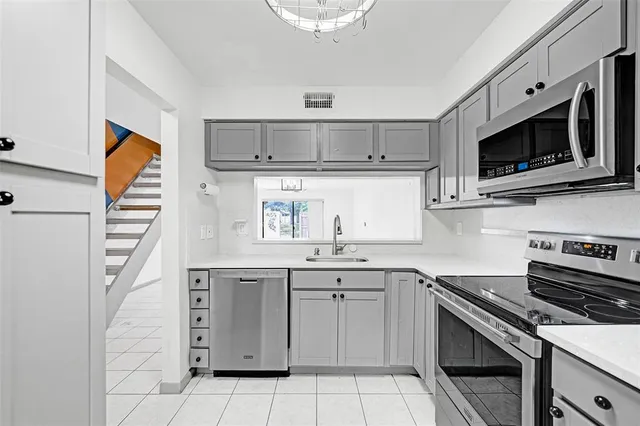 a kitchen with a sink stove and microwave