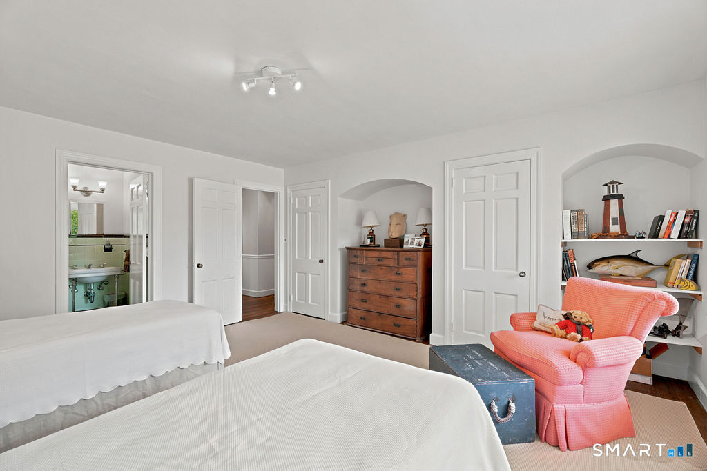 261-1 Grassy Hill Road Lyme, CT 06371 - Photo 22 of 40 Featuring an en-suite full bath and attractive arched alcoves with built-in shelving, this space is rich in character and offers beautiful display opportunities.