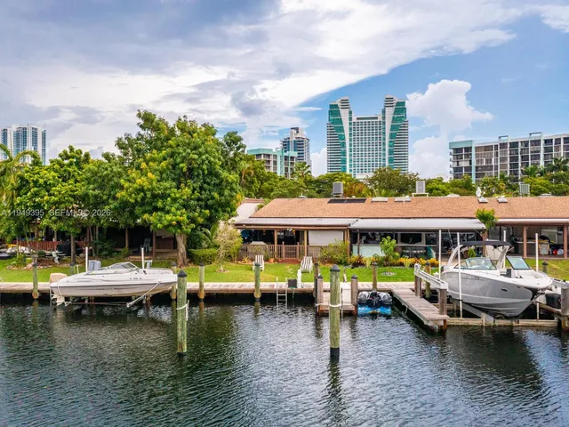 a view of a yard with plants and trees
