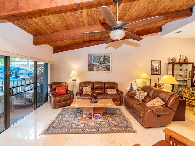 a outdoor patio with swimming pool table and chairs