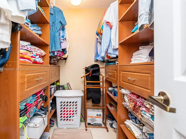 a view of a lake with a table and chairs under an umbrella