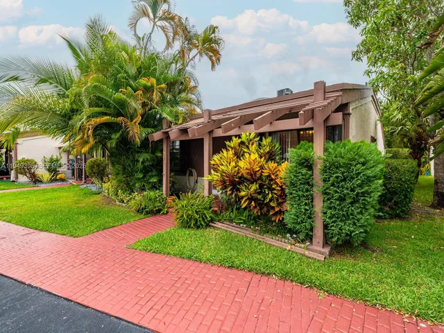 a view of a dining room and livingroom with furniture wooden floor a chandelier