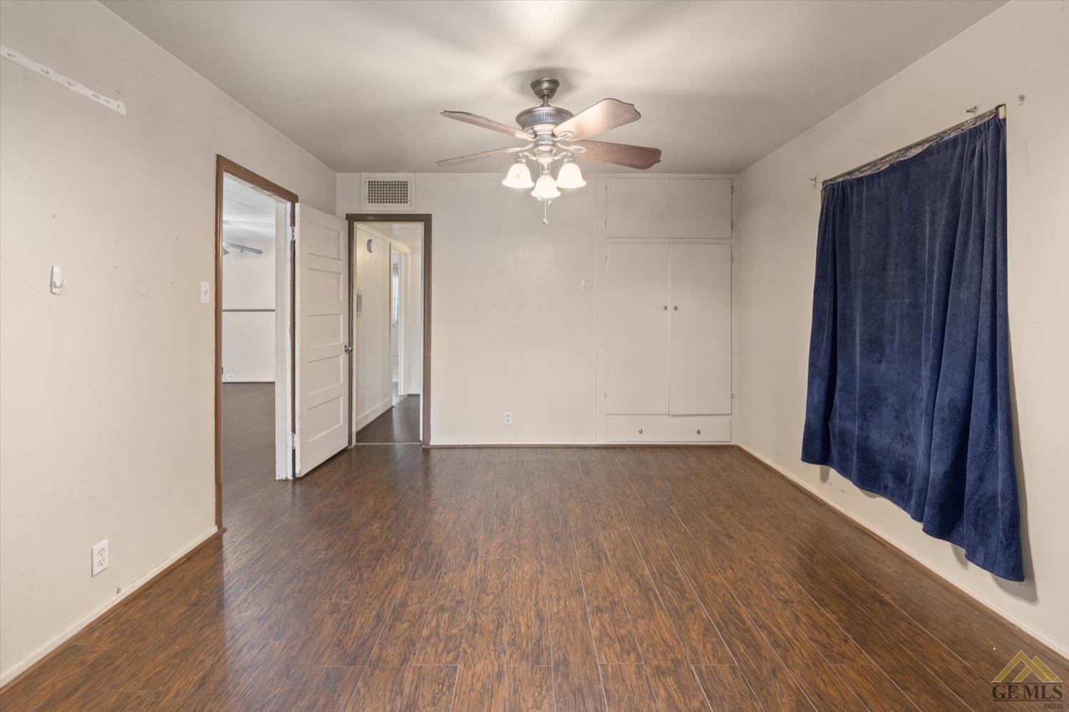 Undisclosed Address Taft, CA 93268 - Photo 11 of 21 an empty room with wooden floor closet and windows