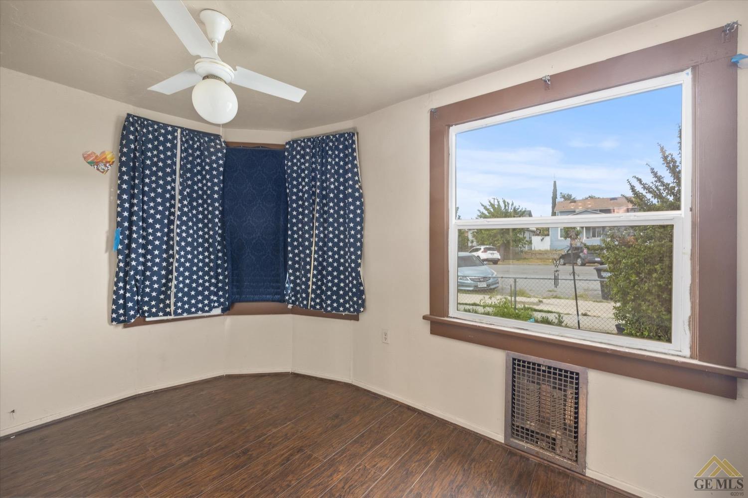 Undisclosed Address Taft, CA 93268 - Photo 9 of 21 an empty room with wooden floor and windows