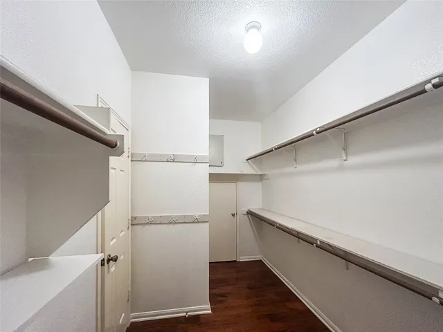 a view of walk in closet with empty racks