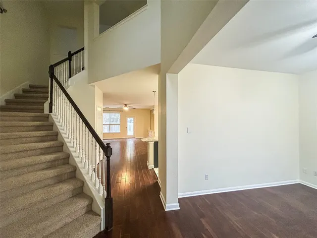 a view of a hallway with wooden floor and entryway