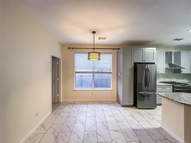 a view of a kitchen with a sink and a refrigerator