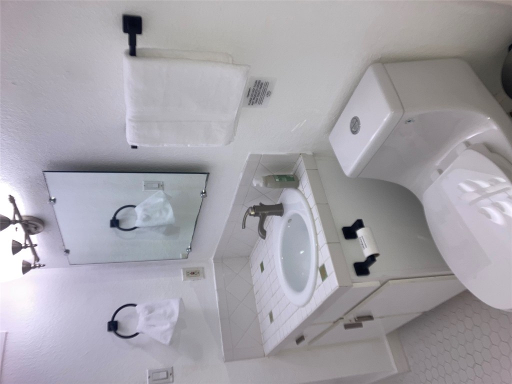 2302 East Side Drive, Unit 30 Austin, TX 78704 - Photo 11 of 22 a bathroom with a sink toilet and mirror